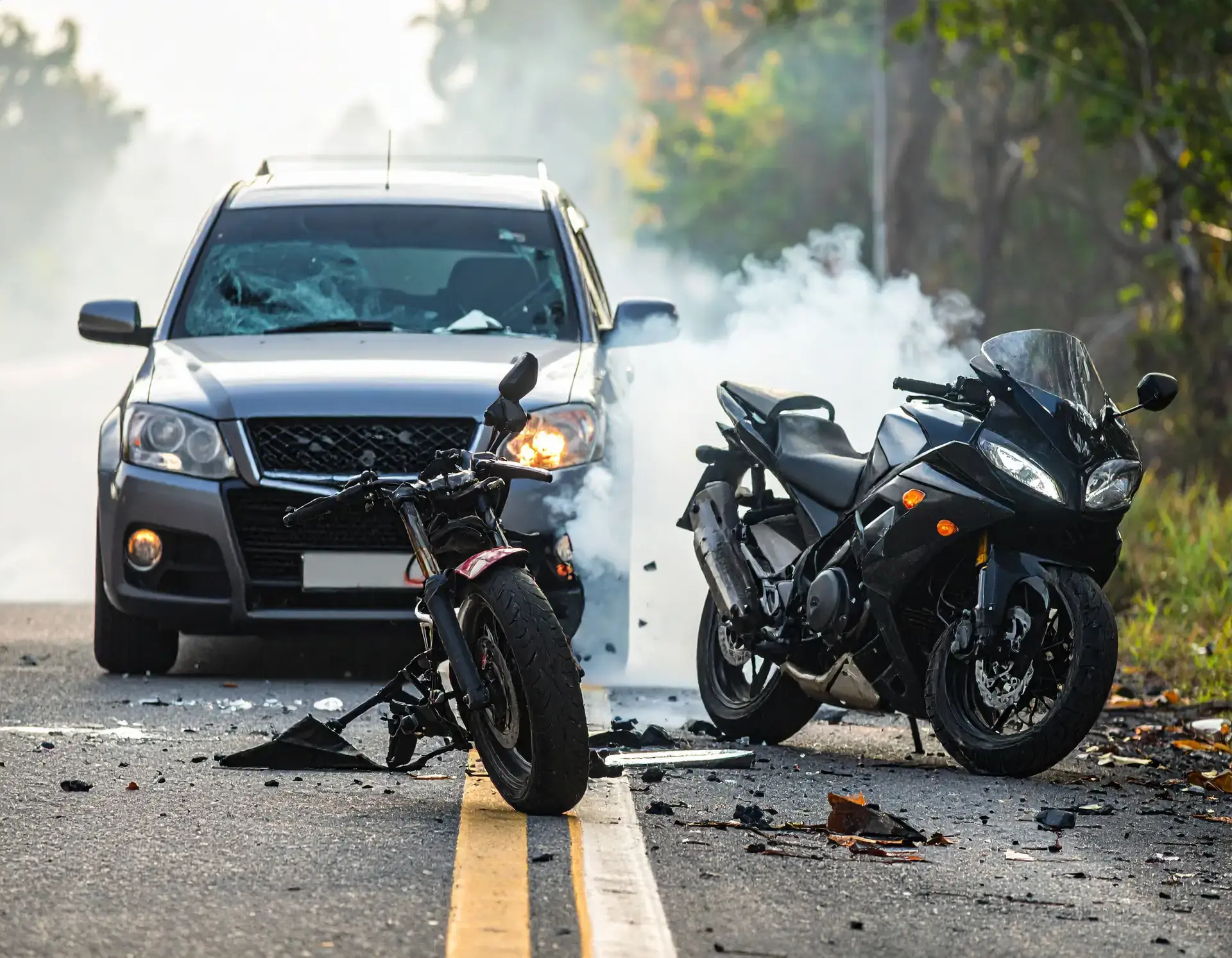 Motorcycle and passenger vehicles on a Florida road at dusk